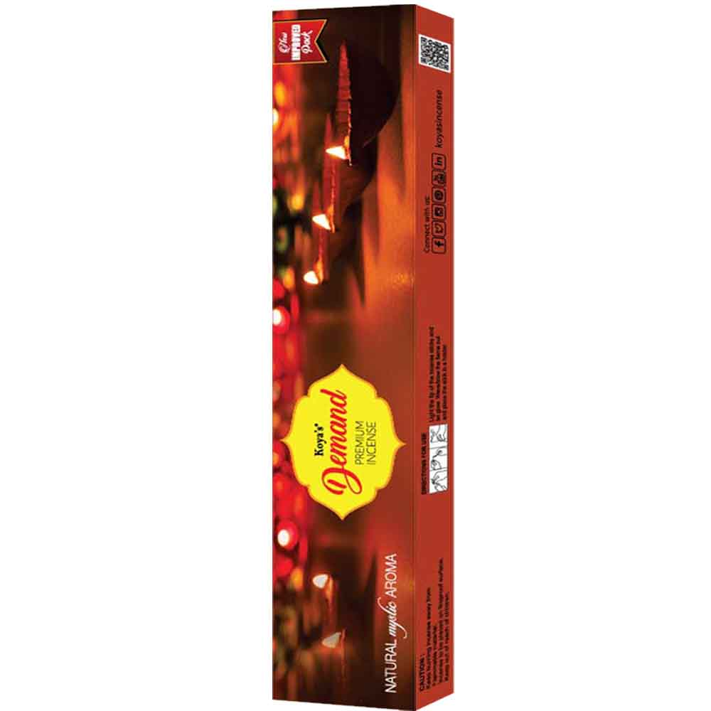 Box of Koya's Demand premium incense featuring a warm, atmospheric photograph of lit diyas (oil lamps). The packaging describes the scent as a 'Natural Mystic Aroma' and indicates it is a 6-in-1 multipack.
