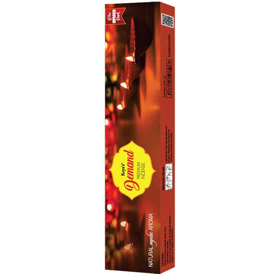 Box of Koya's Demand premium incense featuring a warm, atmospheric photograph of lit diyas (oil lamps). The packaging describes the scent as a 'Natural Mystic Aroma' and indicates it is a 6-in-1 multipack.