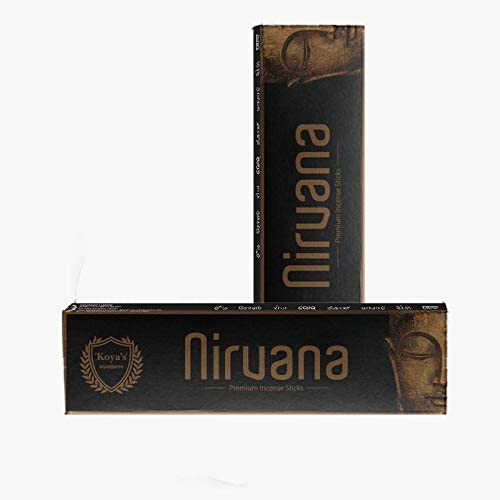 Black rectangular packaging of Koya’s Nirvana incense sticks, featuring bronze lettering with the word “Nirvana” and an image of a serene Buddha face. Two boxes are shown, one standing upright and one lying flat.