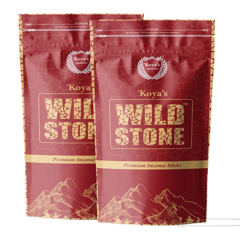 Two pouches of Koya's Wild Stone premium incense in a deep red zipper pouch with a subtle stone pattern. The packaging features the Koya's Agarbathi crest, the brand name in a rugged textured font, and a gold line-art illustration of a mountain range.